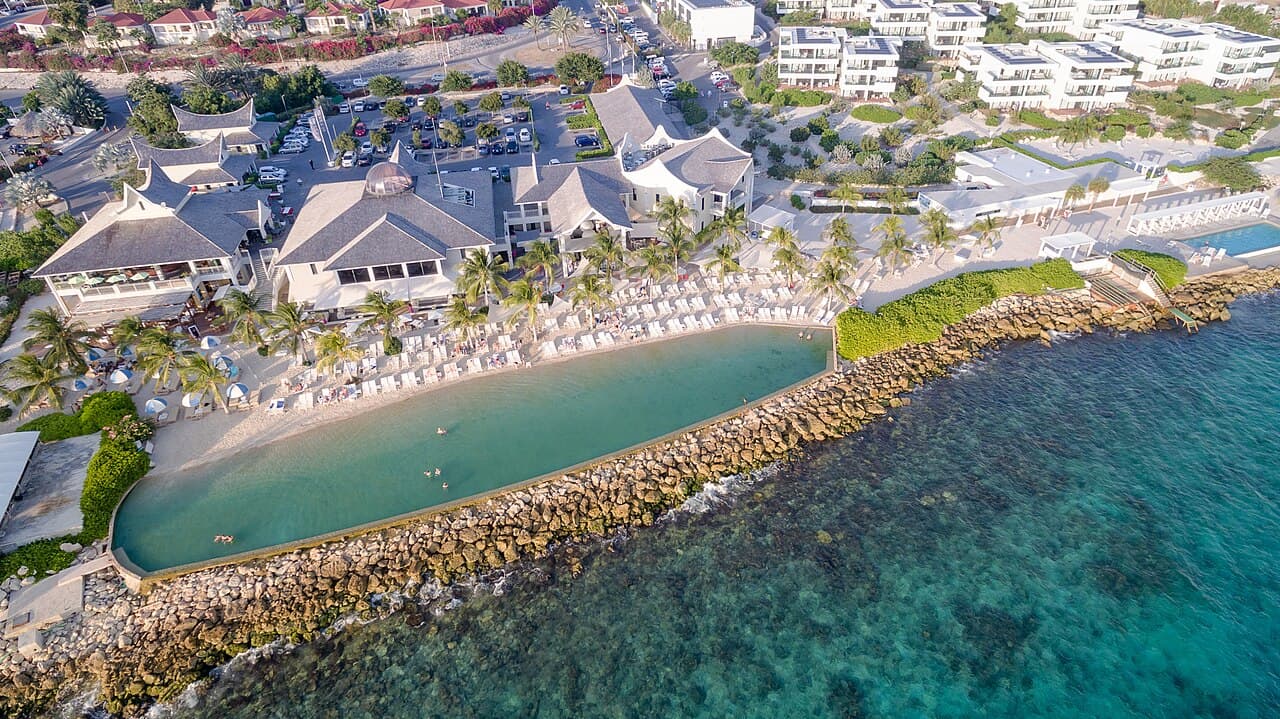 Aerial view of Jan Thiel Bay resort with beach, pool and loungers on Curaçao