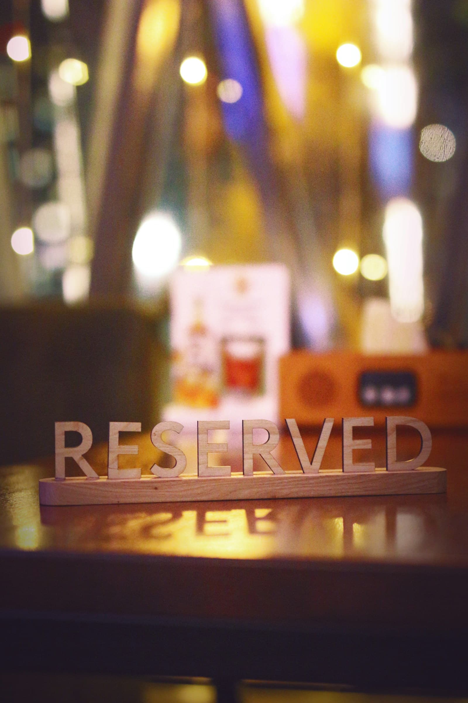 Reserved table sign on a restaurant table with warm evening lighting